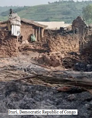 A picture of an abandoned and destroyed village in Ituri, Democratic Republic of Congo. The mud houses have been burned and there is a lot of ash on the ground.
